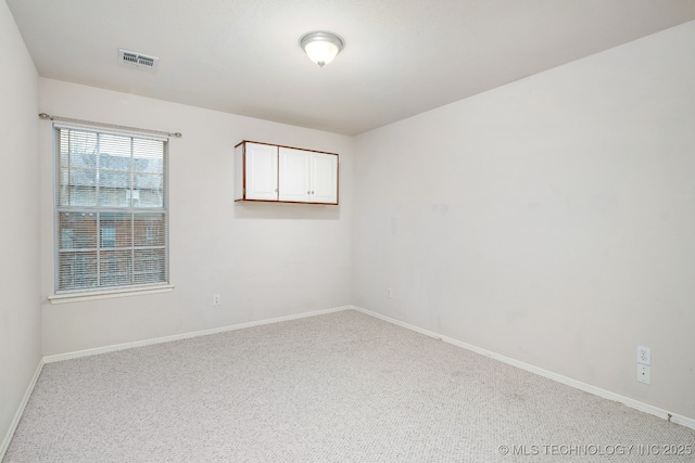 spare room with light colored carpet