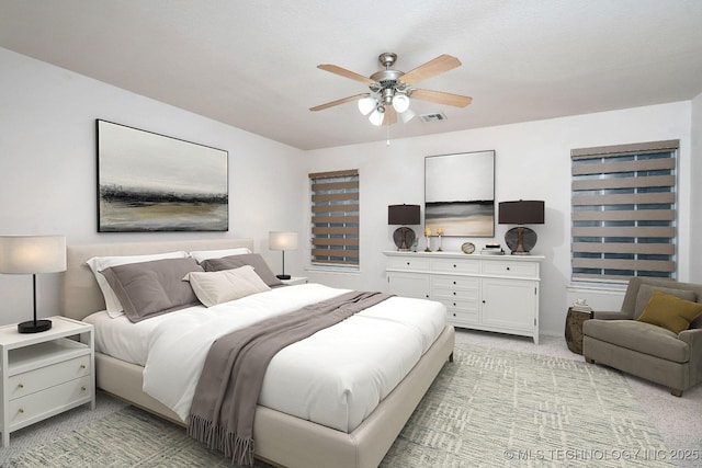 bedroom featuring ceiling fan and light carpet