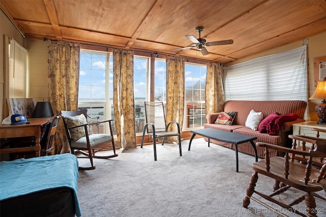 sunroom featuring ceiling fan, a water view, and wood ceiling