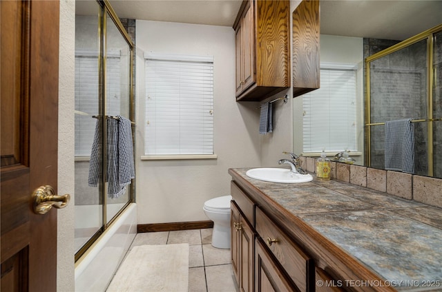 8775 Leonard St, Kingston, OK 73439 - full bathroom featuring vanity, combined bath / shower with glass door, tile patterned floors, and toilet