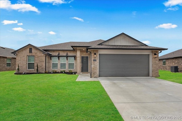 view of front of house with a garage, central AC, and a front yard