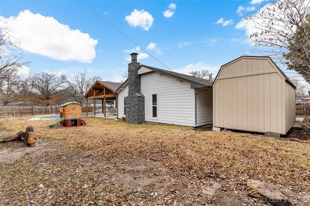 view of side of home featuring a playground and a shed