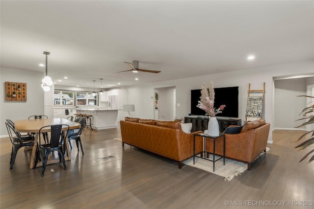 living room with dark hardwood / wood-style floors and ceiling fan