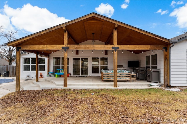 back of house with a patio and outdoor lounge area