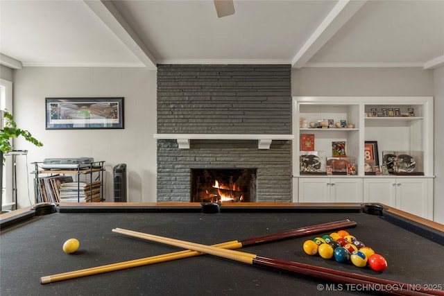 rec room with ceiling fan, billiards, ornamental molding, and a fireplace