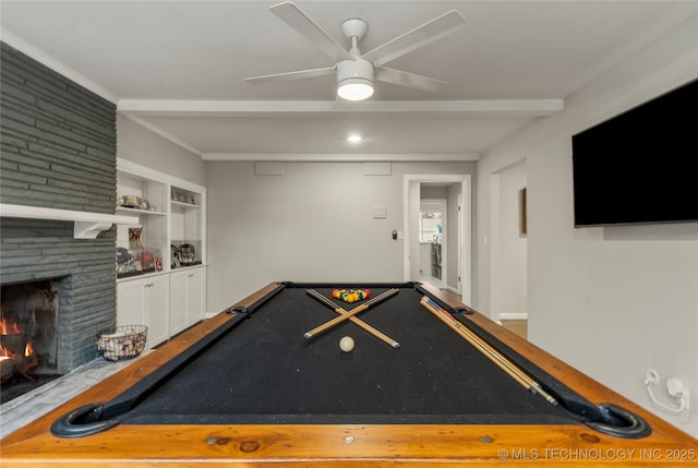 rec room with built in features, a fireplace, billiards, ceiling fan, and beam ceiling