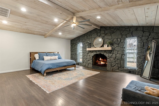 bedroom featuring wood ceiling, a fireplace, dark hardwood / wood-style floors, and vaulted ceiling with beams