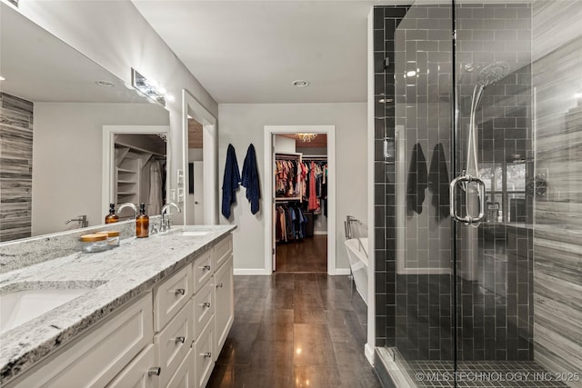 bathroom with vanity, hardwood / wood-style flooring, and plus walk in shower