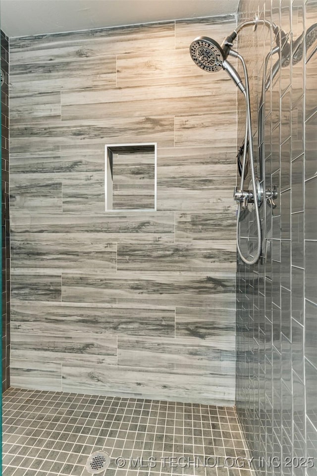 bathroom with a tile shower