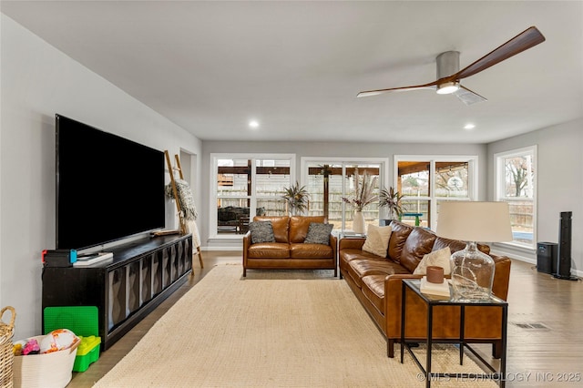 living room with hardwood / wood-style floors and ceiling fan