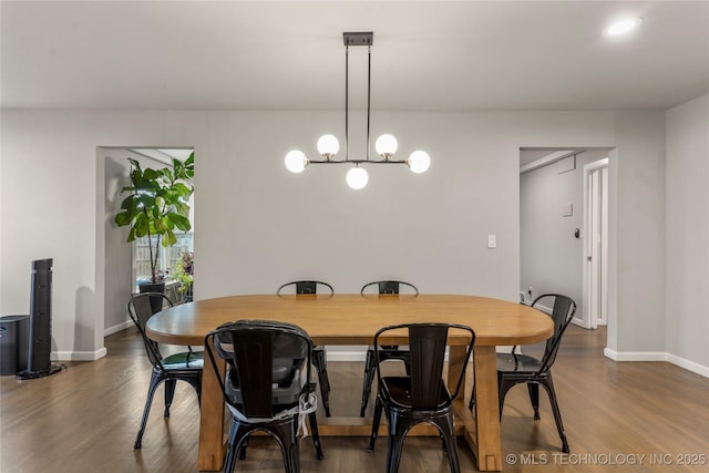 dining room with an inviting chandelier and dark hardwood / wood-style floors