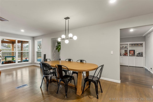 dining room featuring dark hardwood / wood-style floors and a chandelier