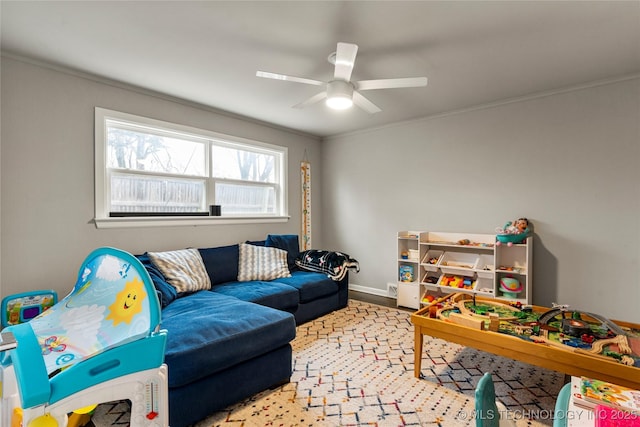 living room featuring ceiling fan and ornamental molding