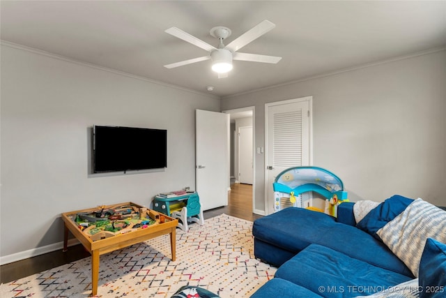 living room with crown molding, hardwood / wood-style floors, and ceiling fan