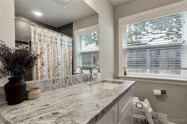 bathroom with vanity and curtained shower