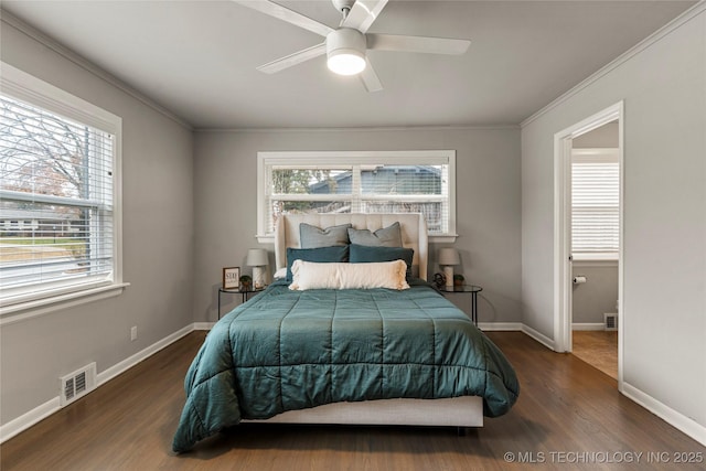 bedroom featuring dark wood-type flooring, ceiling fan, and crown molding