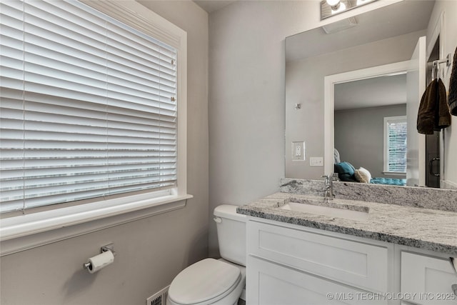 bathroom featuring vanity and toilet