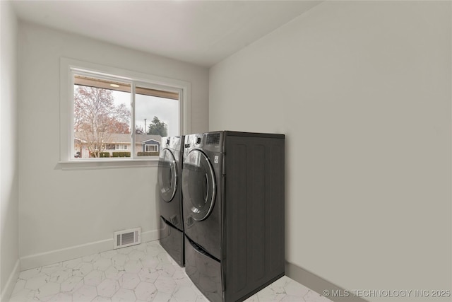 laundry area with independent washer and dryer