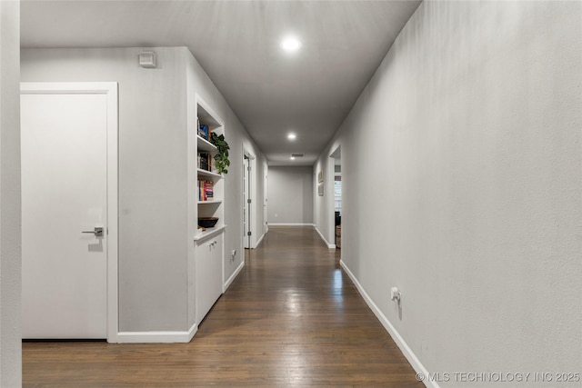 corridor with dark hardwood / wood-style floors