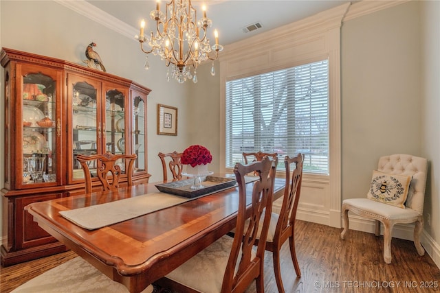 dining room with hardwood / wood-style flooring and ornamental molding