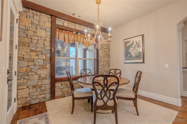 dining room featuring an inviting chandelier and hardwood / wood-style floors