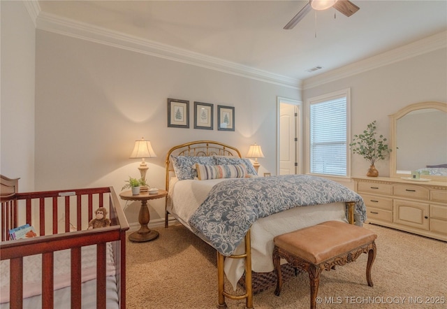 carpeted bedroom with crown molding and ceiling fan