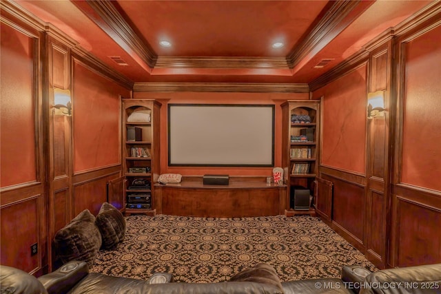 home theater room featuring crown molding and a raised ceiling