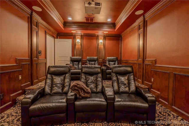 carpeted cinema featuring crown molding and a tray ceiling