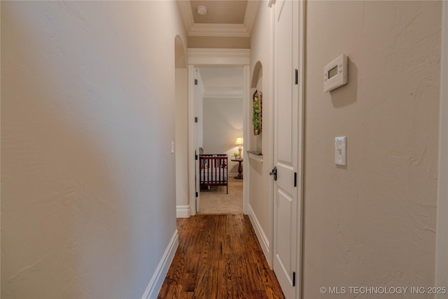 hall featuring crown molding and dark wood-type flooring