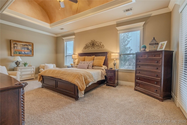 bedroom with crown molding, light colored carpet, a raised ceiling, and ceiling fan