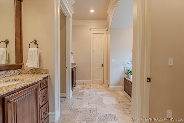 bathroom with ornamental molding, a bath, decorative columns, and vanity