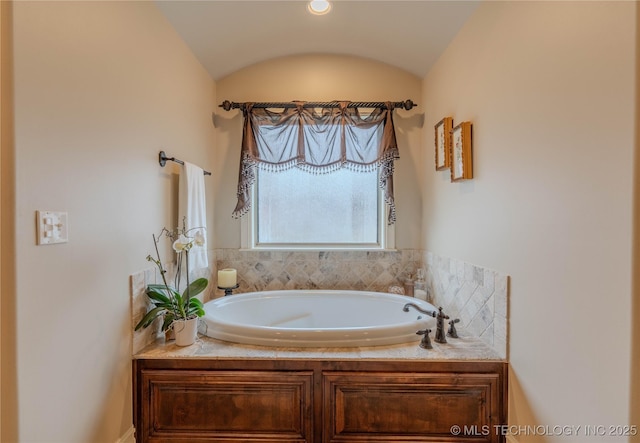 bathroom featuring lofted ceiling and a tub