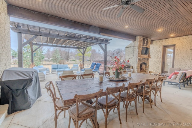 view of patio with an outdoor living space with a fireplace, a grill, ceiling fan, and a pergola