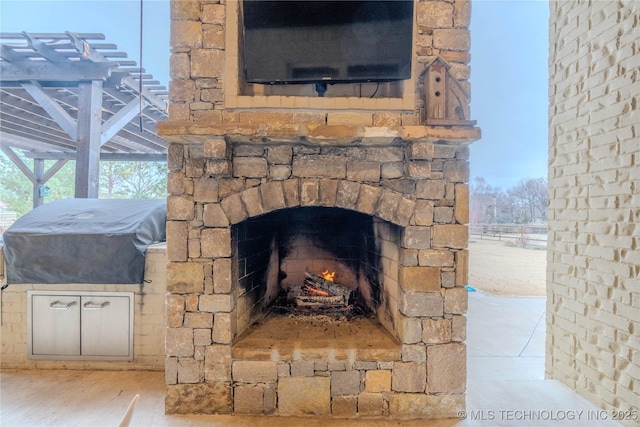 exterior details featuring an outdoor stone fireplace