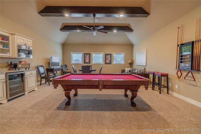 recreation room with wine cooler, light colored carpet, ceiling fan, and vaulted ceiling with beams