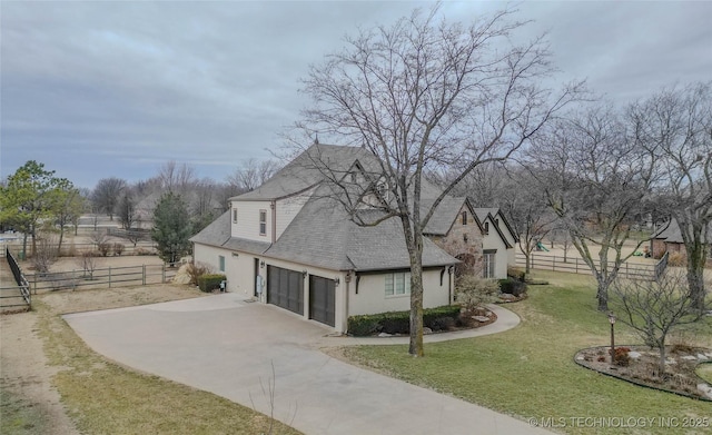 view of property exterior featuring a garage and a lawn