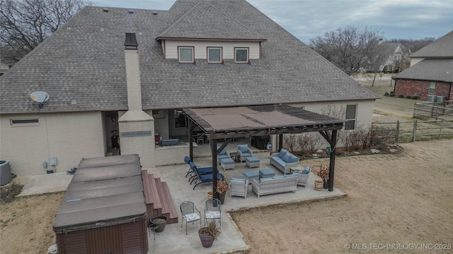 rear view of house featuring an outdoor living space, a hot tub, a patio, and central air condition unit