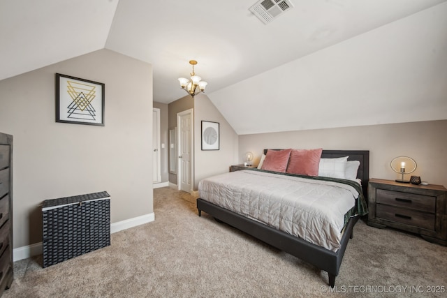 bedroom with a chandelier, vaulted ceiling, and light carpet