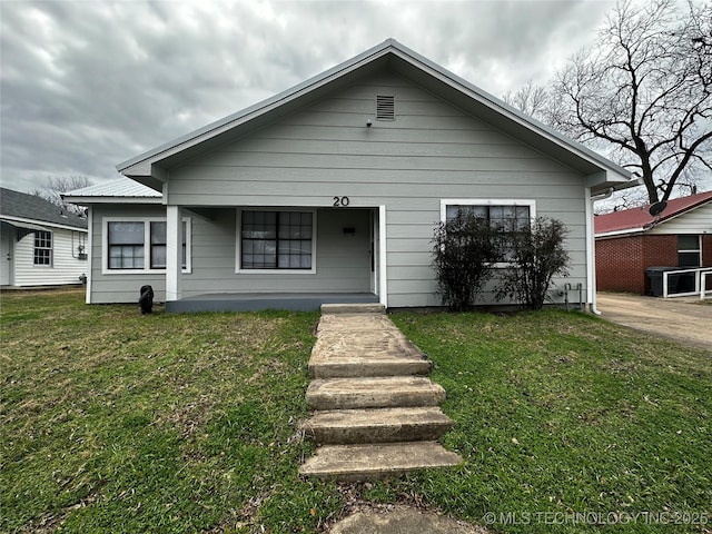 bungalow-style house with a front yard