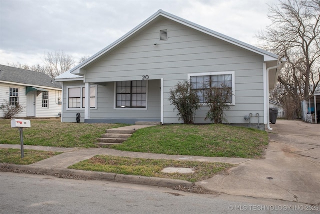 bungalow-style home featuring a front yard