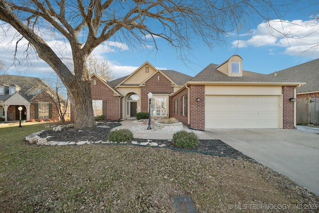 view of front of property featuring a garage and a front yard