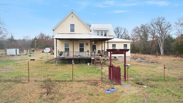 rear view of property with a lawn and covered porch