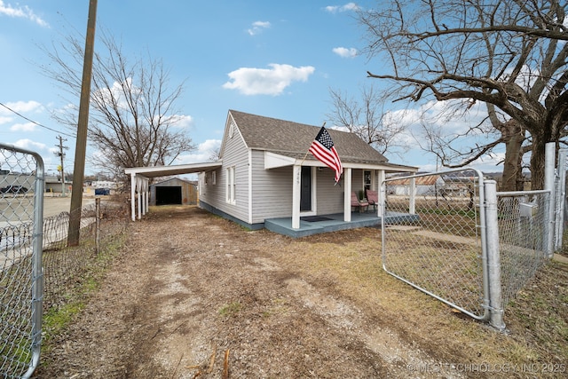 view of side of home with a porch and a carport