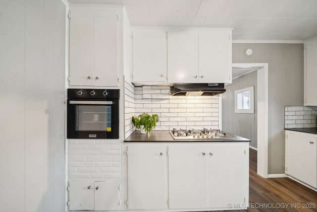 kitchen featuring dark hardwood / wood-style floors, black oven, tasteful backsplash, white cabinetry, and stainless steel gas stovetop