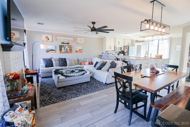 dining area with ornamental molding and ceiling fan