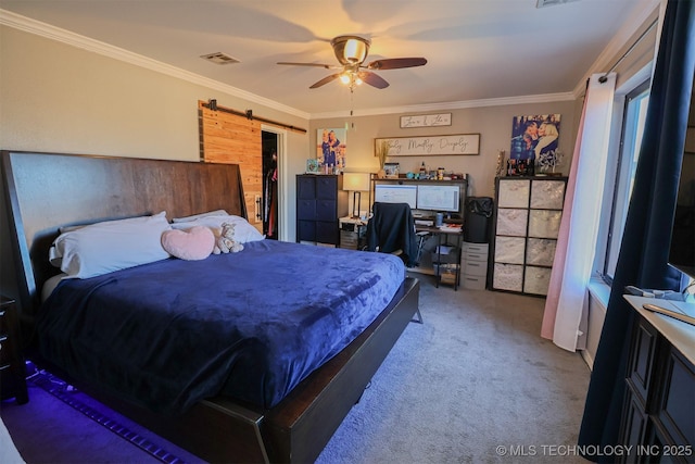 bedroom with carpet floors, ornamental molding, a spacious closet, ceiling fan, and a barn door