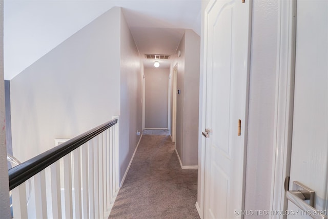 hall with light colored carpet