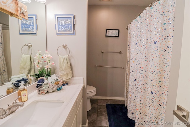 bathroom with a shower with curtain, vanity, tile patterned flooring, and toilet