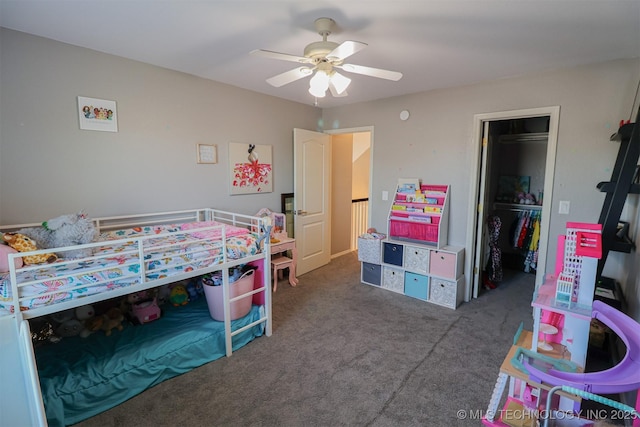 bedroom with ceiling fan, dark carpet, and a closet