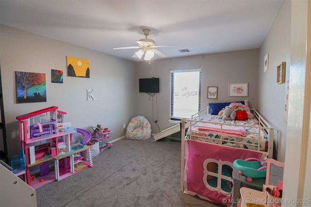 bedroom featuring ceiling fan and carpet